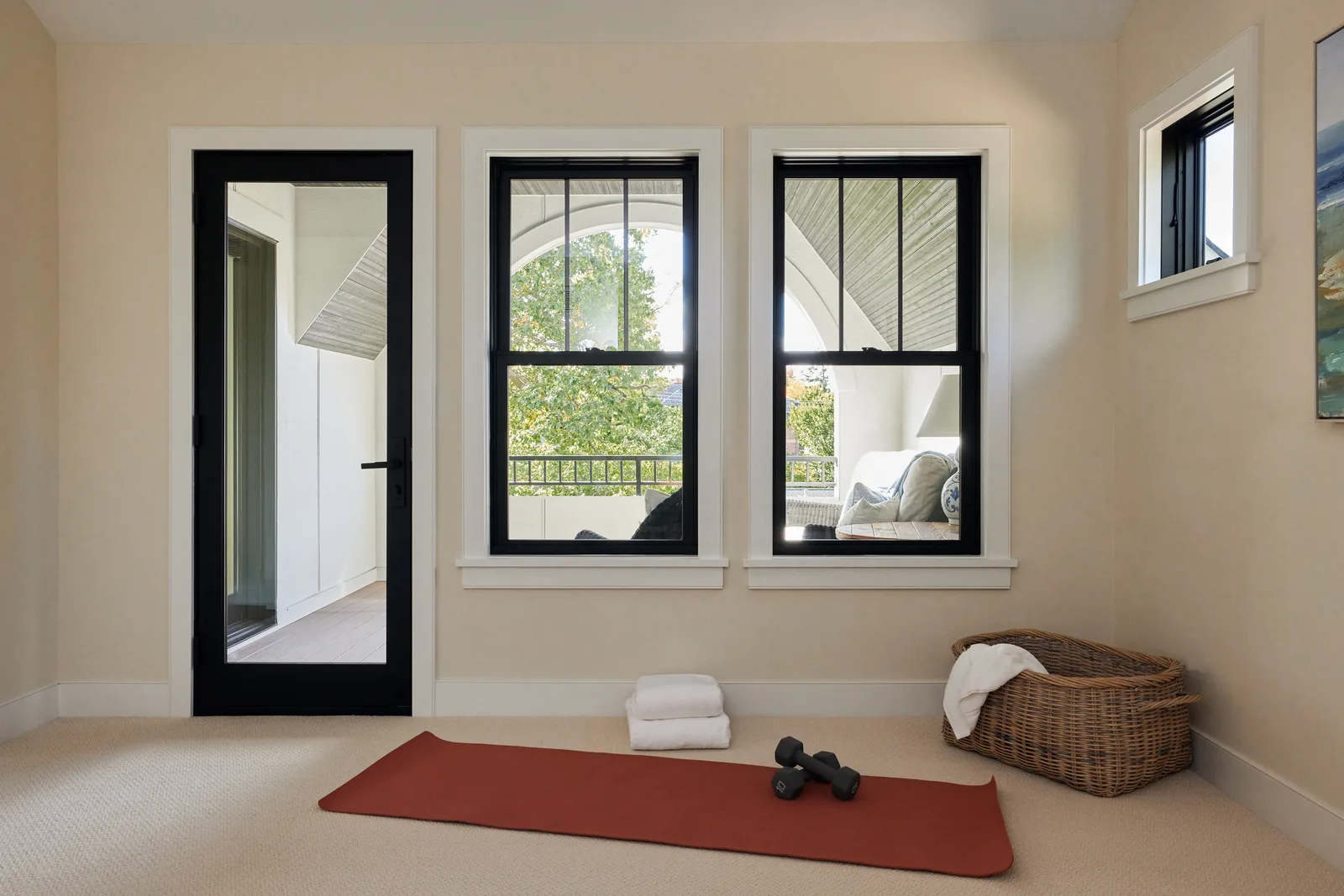 Black-framed windows and a glass door in a bright interior